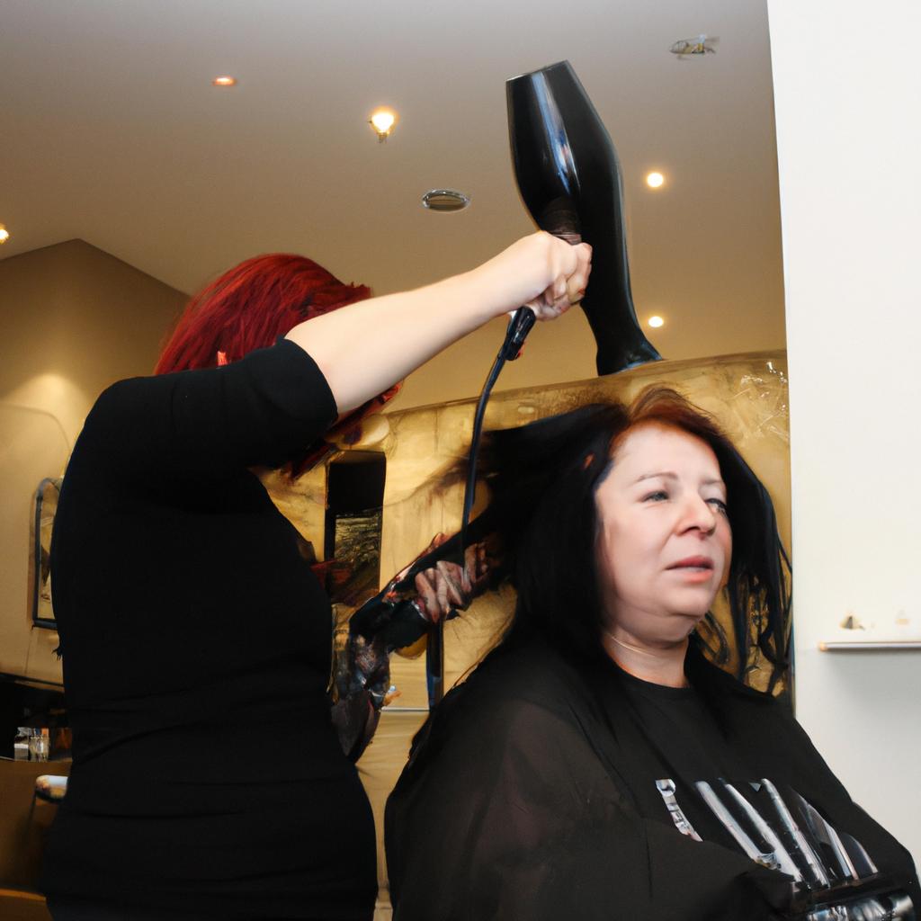Woman blow drying client's hair